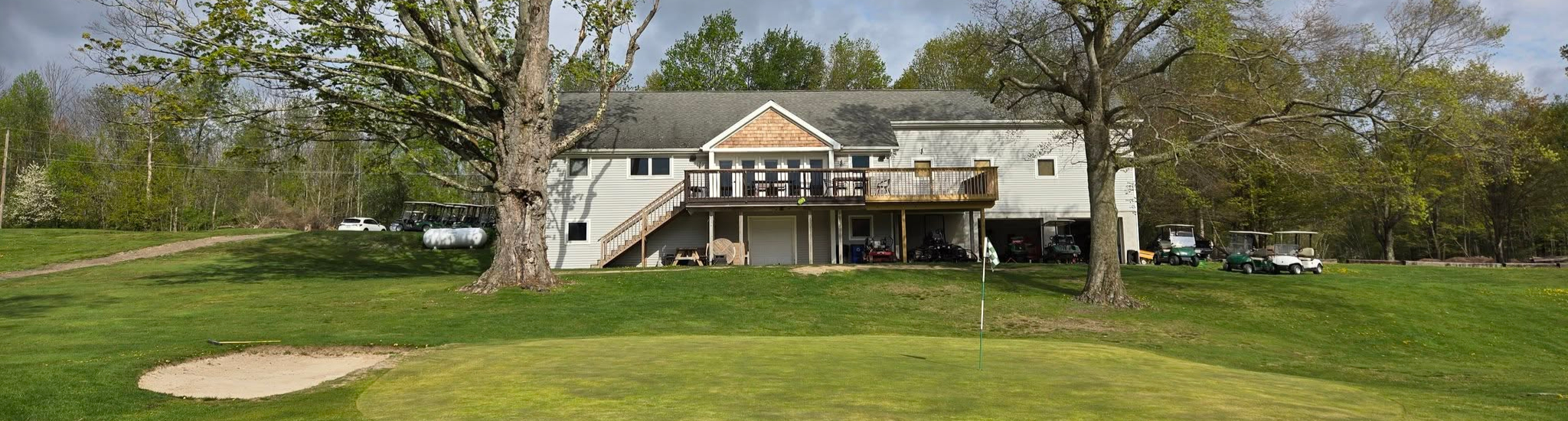 Image of golf ball on tee on grass.